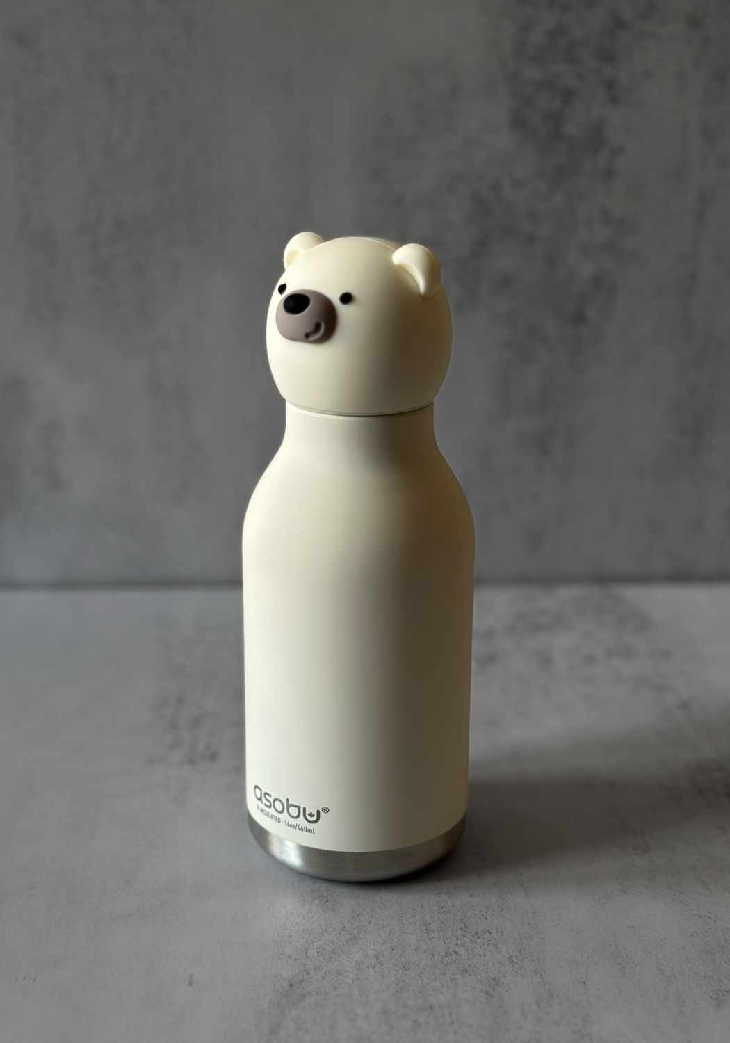 Cream insulated stainless steel water bottle with novelty polar bear head lid.