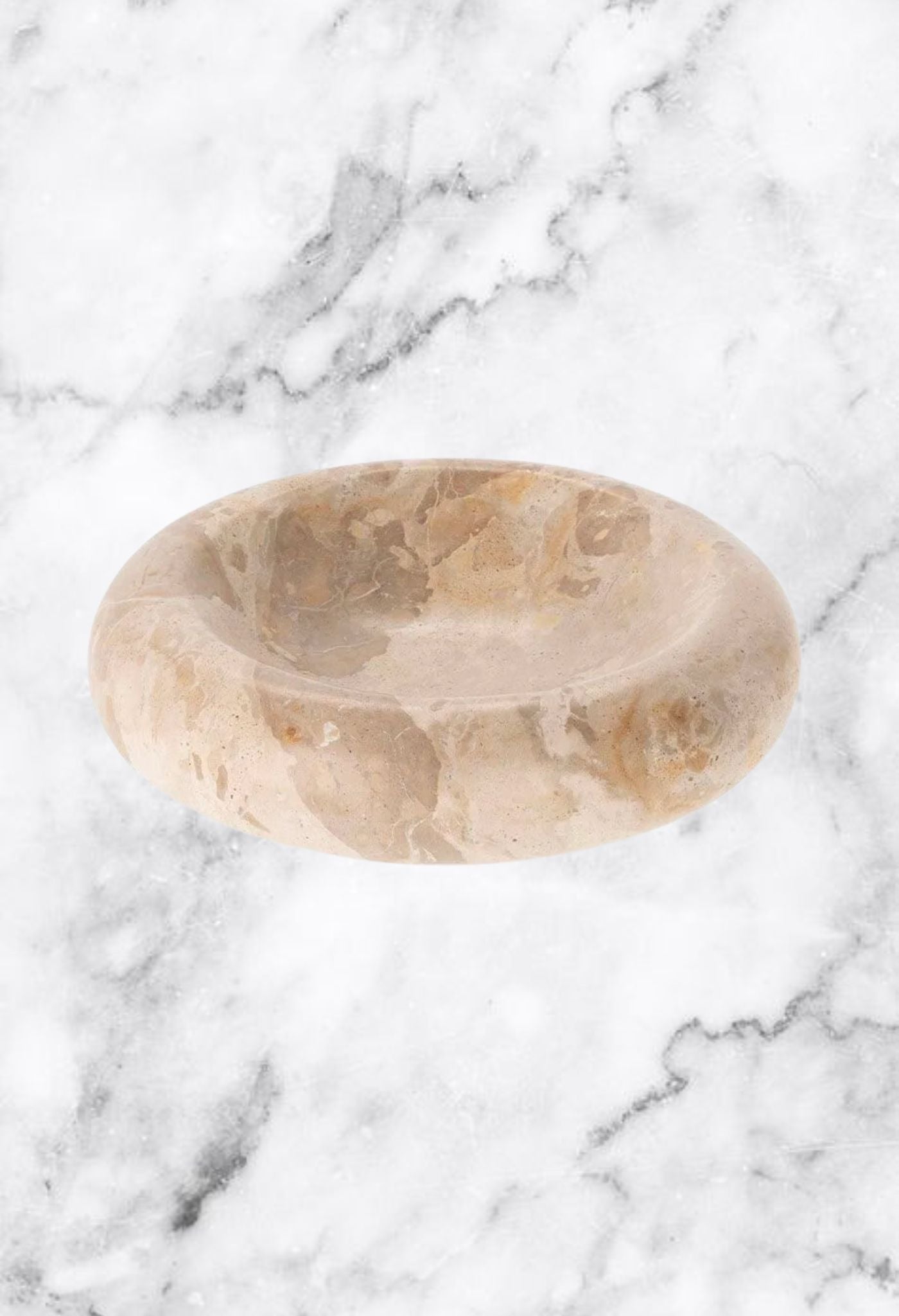 Two round marble trays with grey and tan veining on a dark surface.