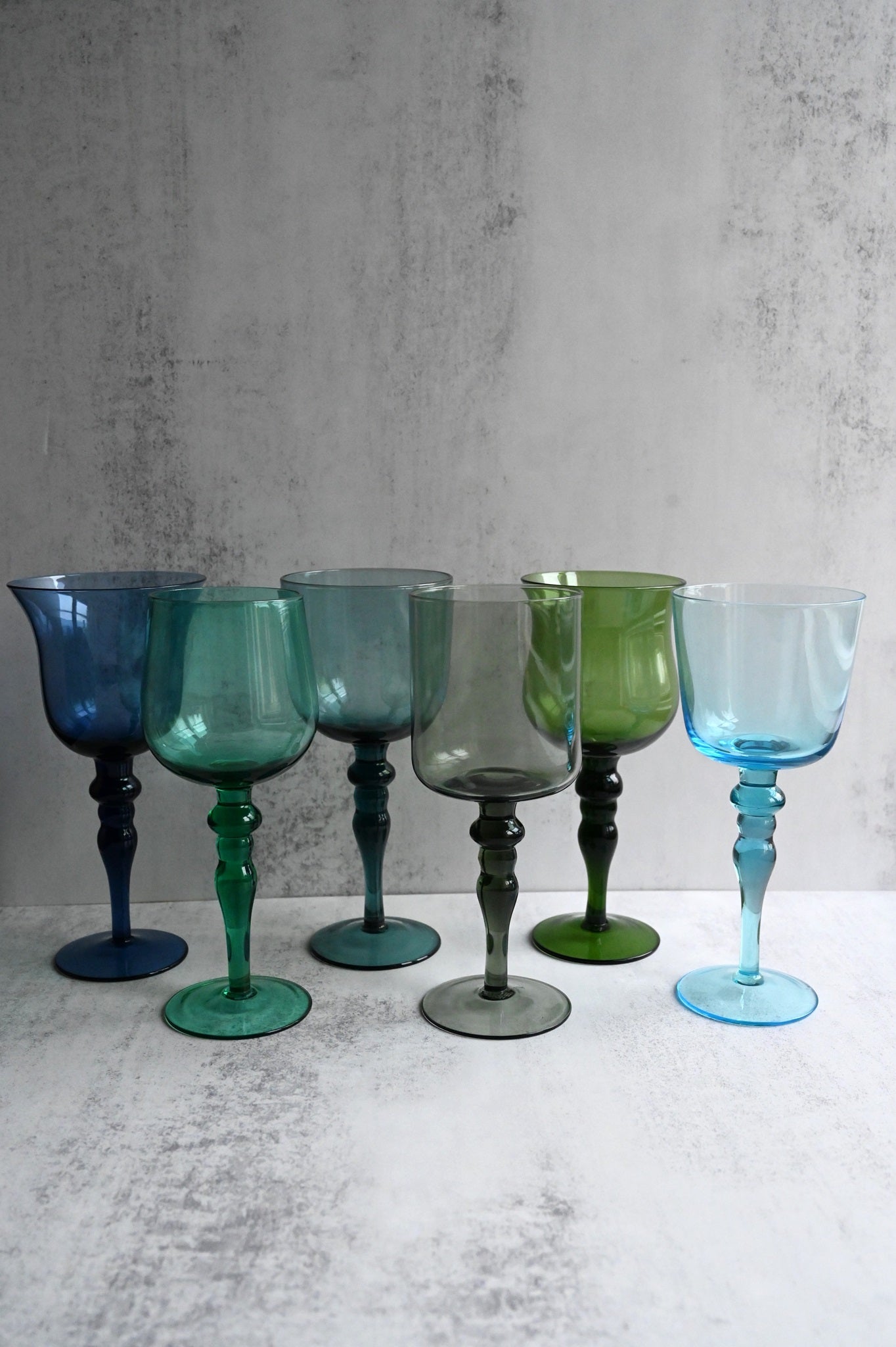 Set of six assorted hand-blown Art Nouveau style wine glasses in jewel tones.