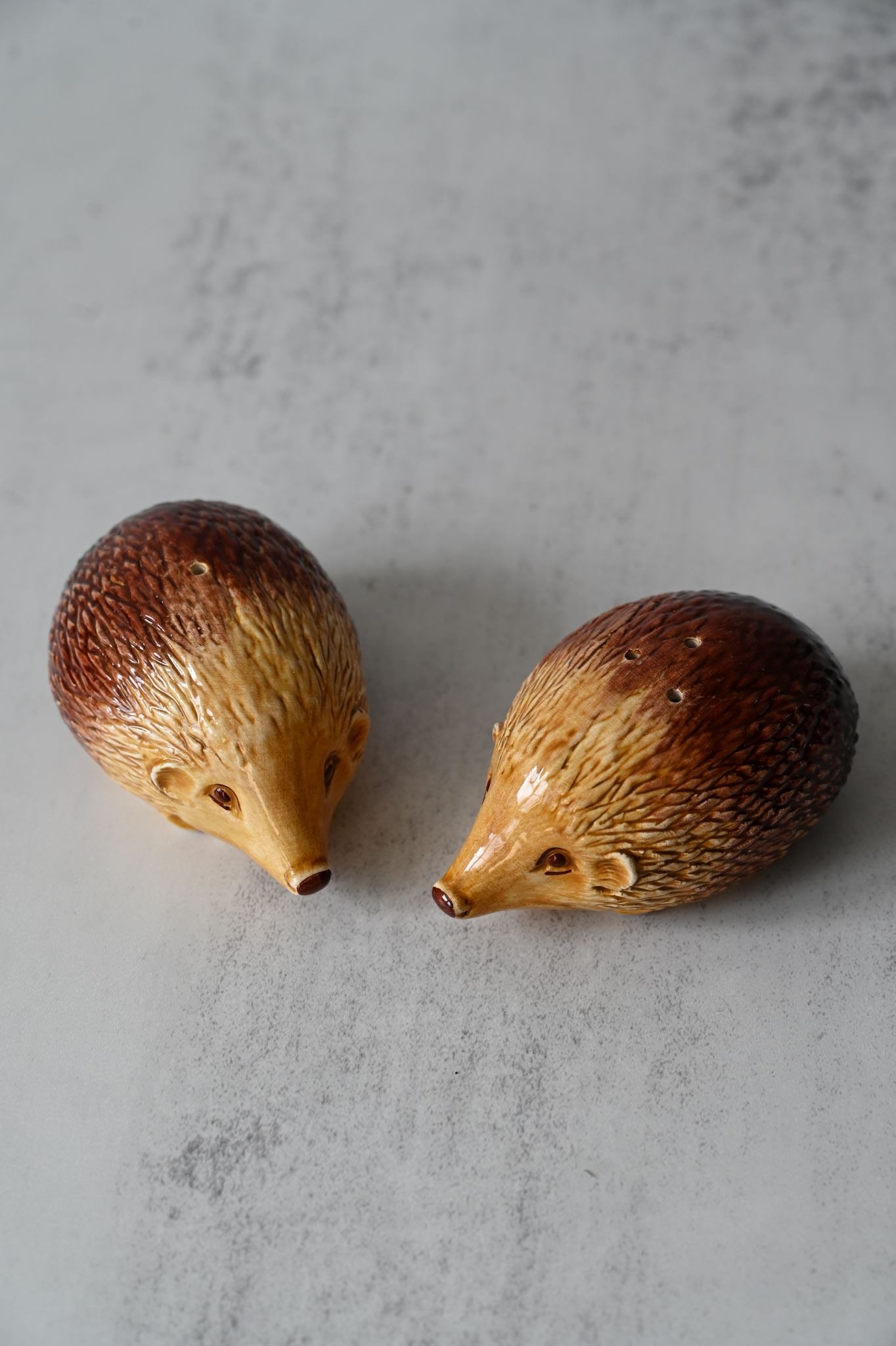 Pair of glossy brown ceramic hedgehog salt and pepper shakers