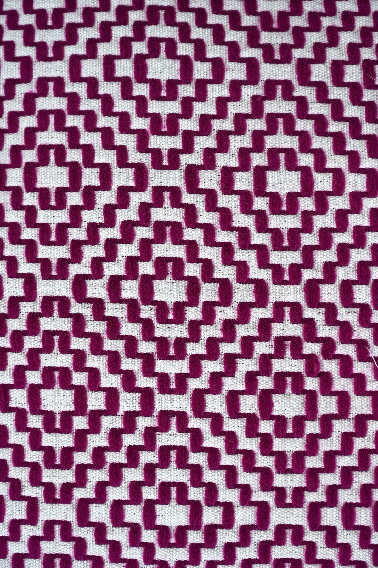 Patterned fabric with a geometric design in purple and white