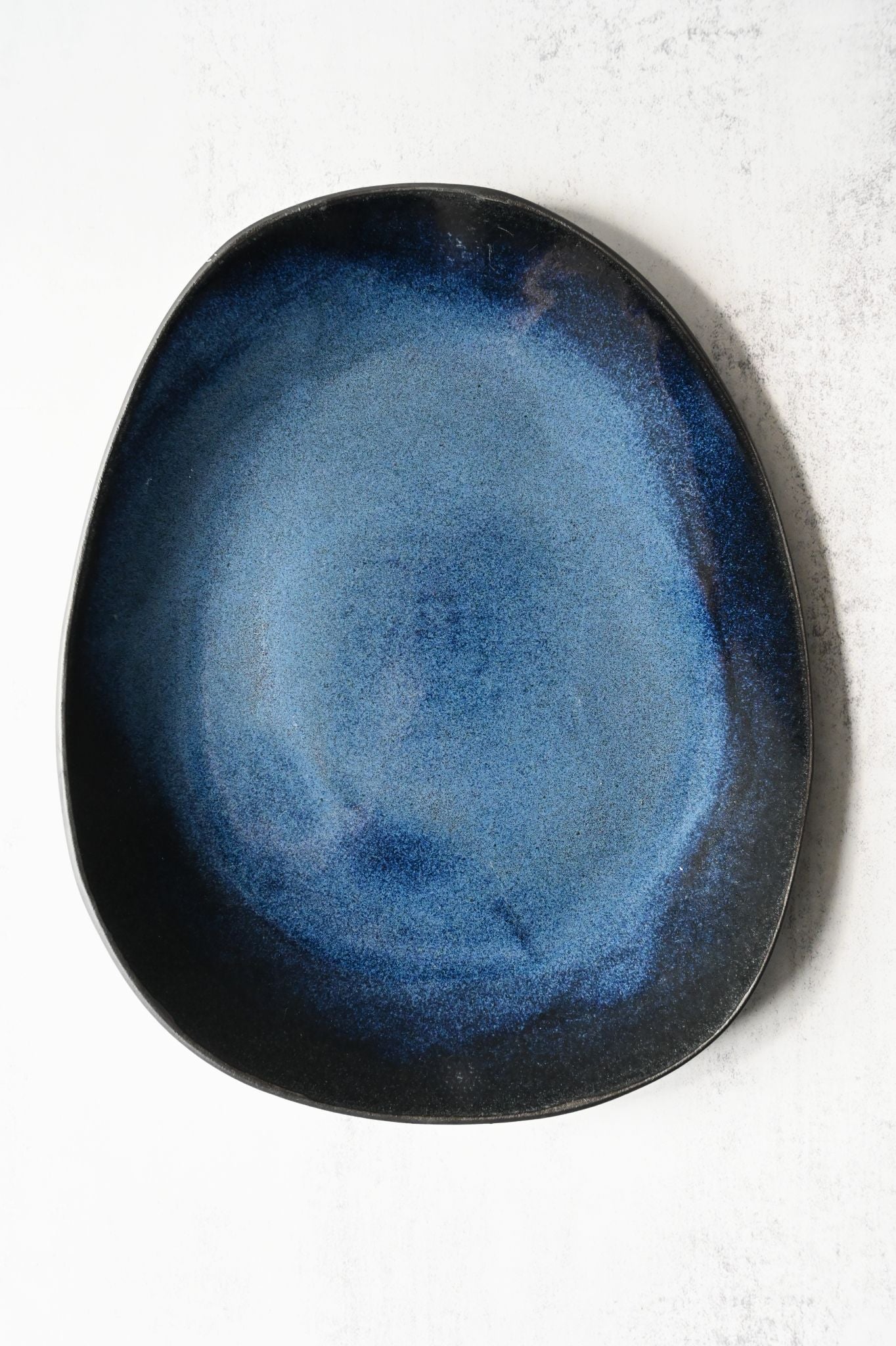 Hana Karim large hand-thrown stoneware platter with cosmic blue reactive glaze.
