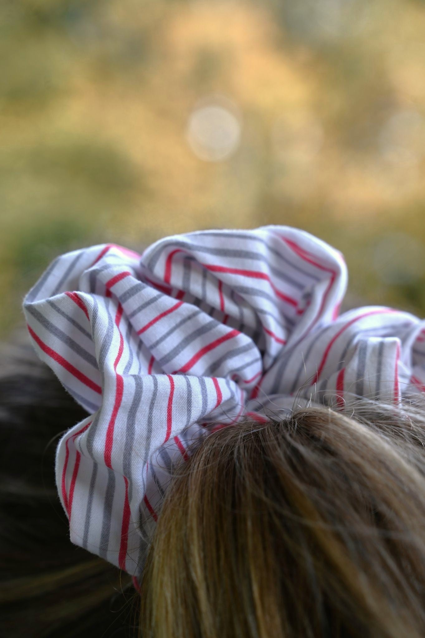 Striped scrunchie on a blurred natural background