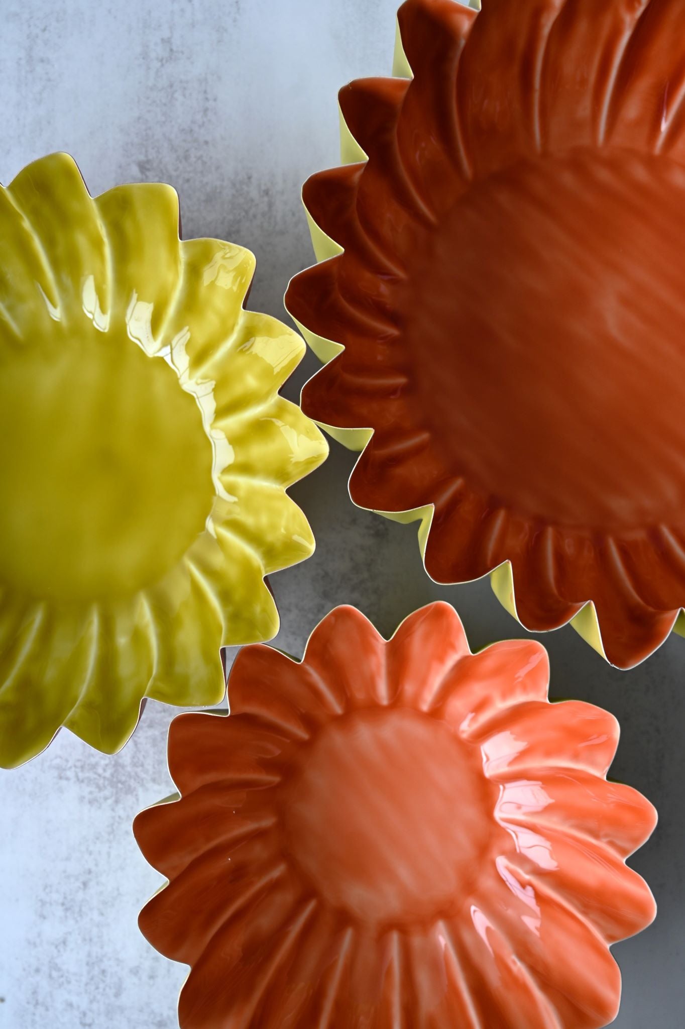 Orangefarbene Schalen mit Sonnenblumenmuster und Wellenrand
