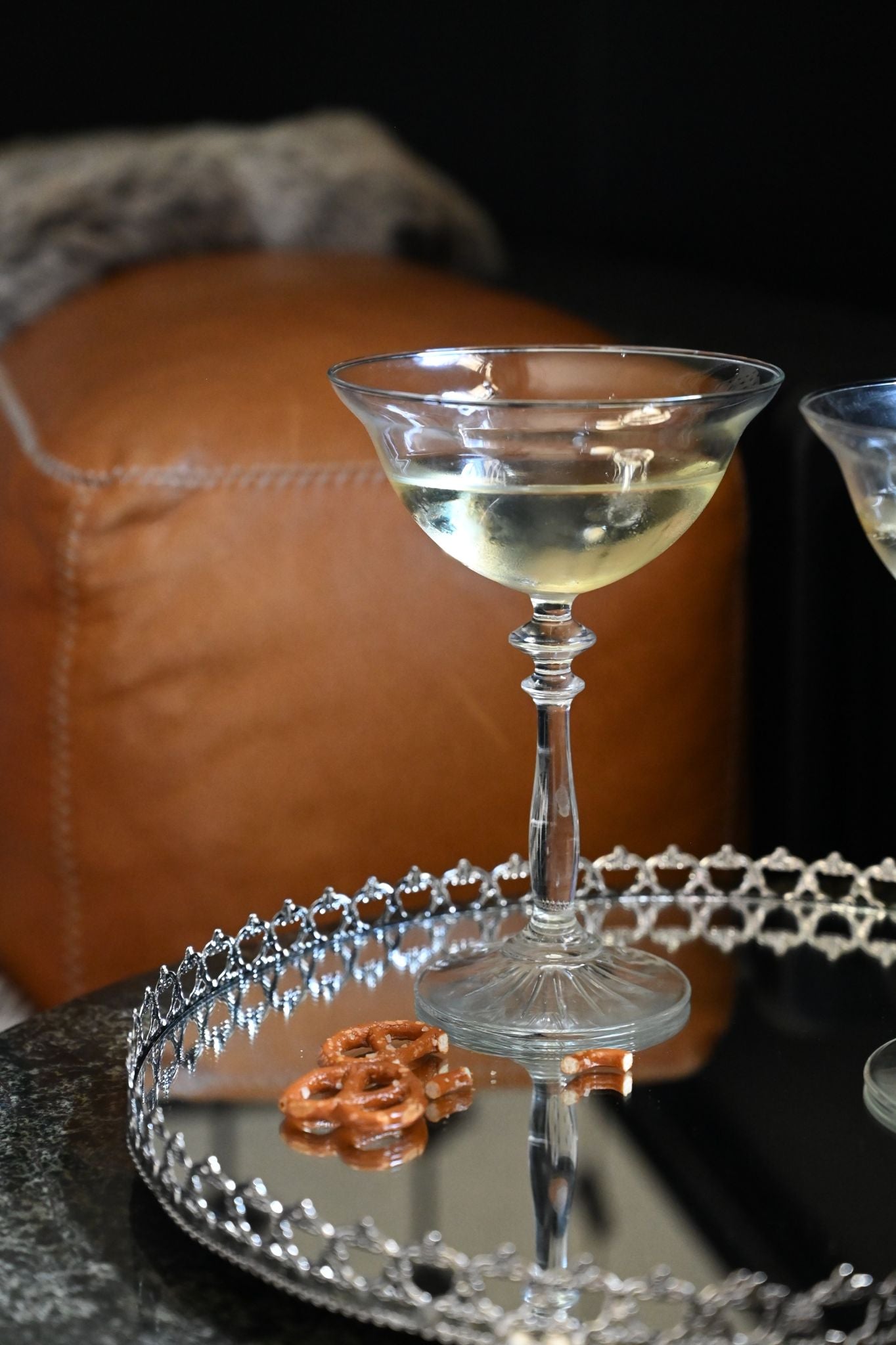 Set of two clear glass Georgian style champagne coupes with ornate stems.