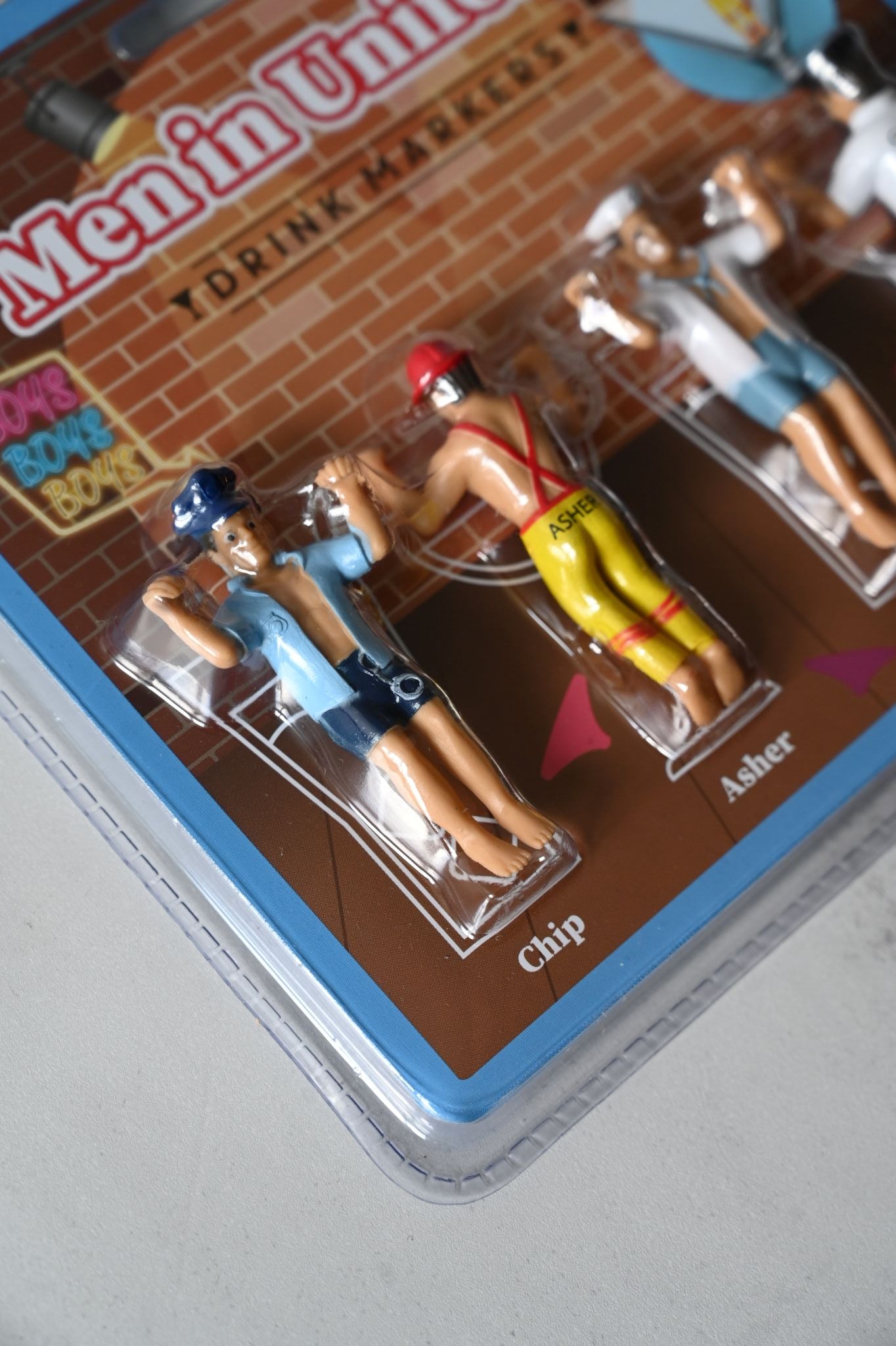 Packaged drinks markers of men in uniform, four pack on grey background