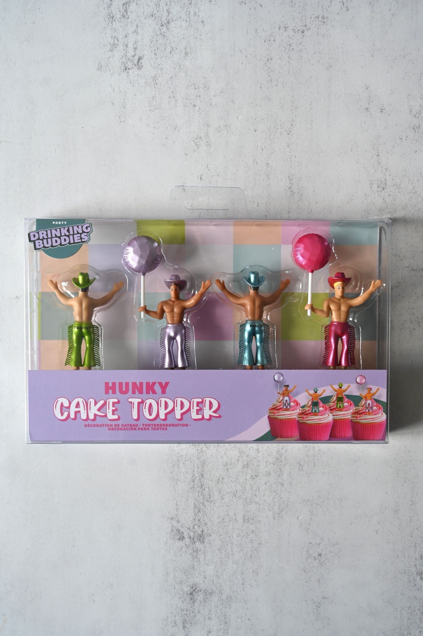 Box of Hunky Cake Topper with figures and lollipops on a gray background