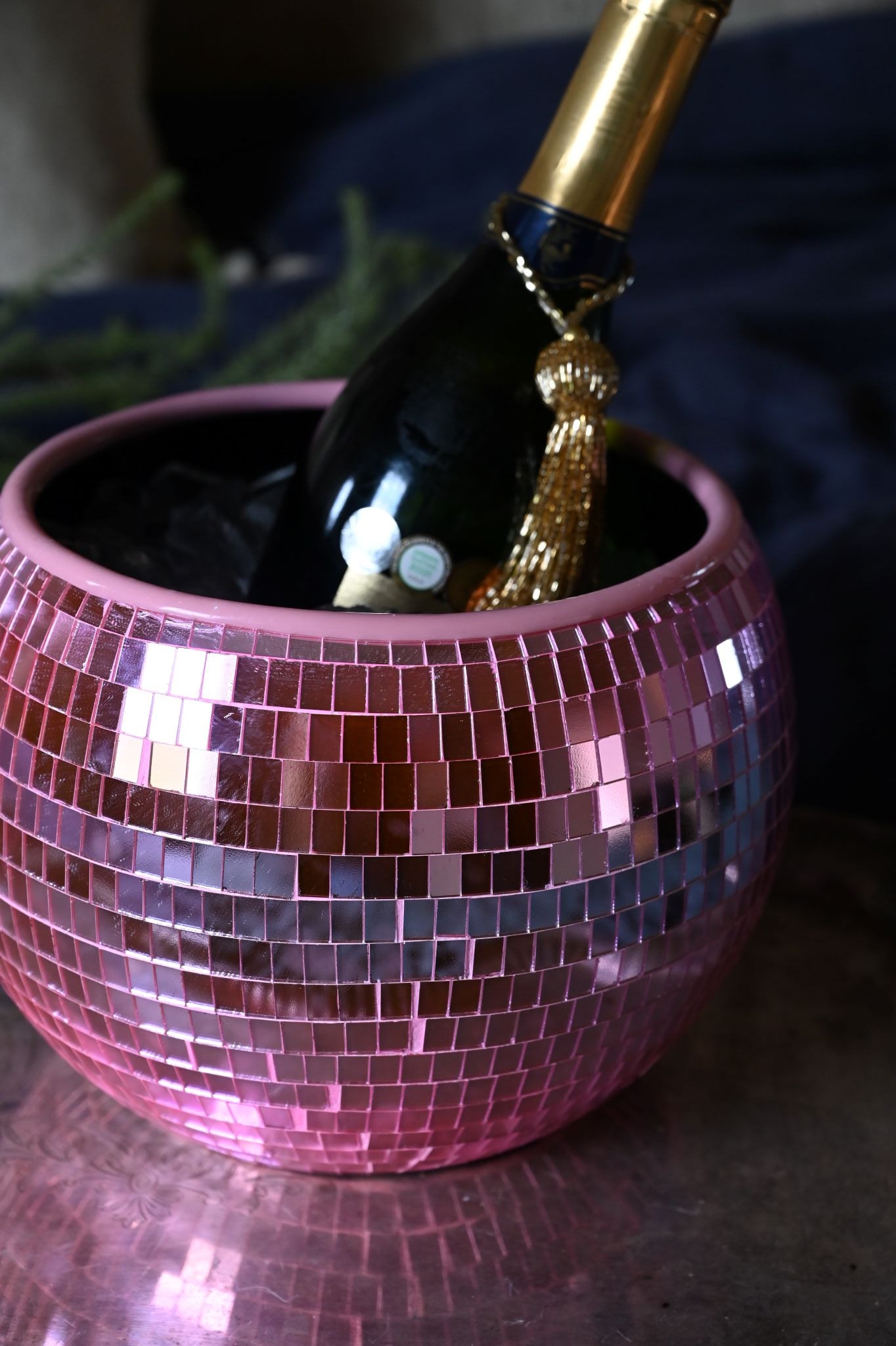 Pink disco ball ice bucket with a champagne bottle inside.