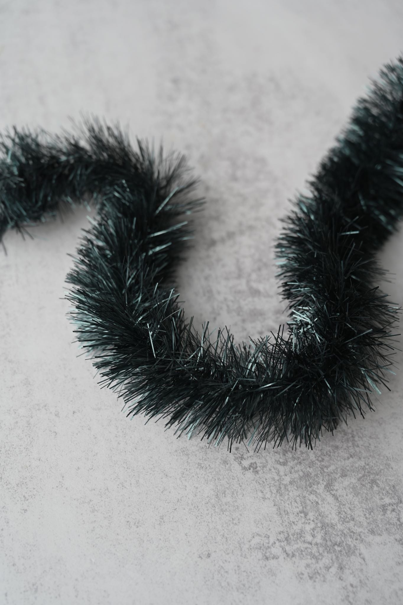 Chunky luxury tinsel garland in dark petrol blue with a subtle sparkle.