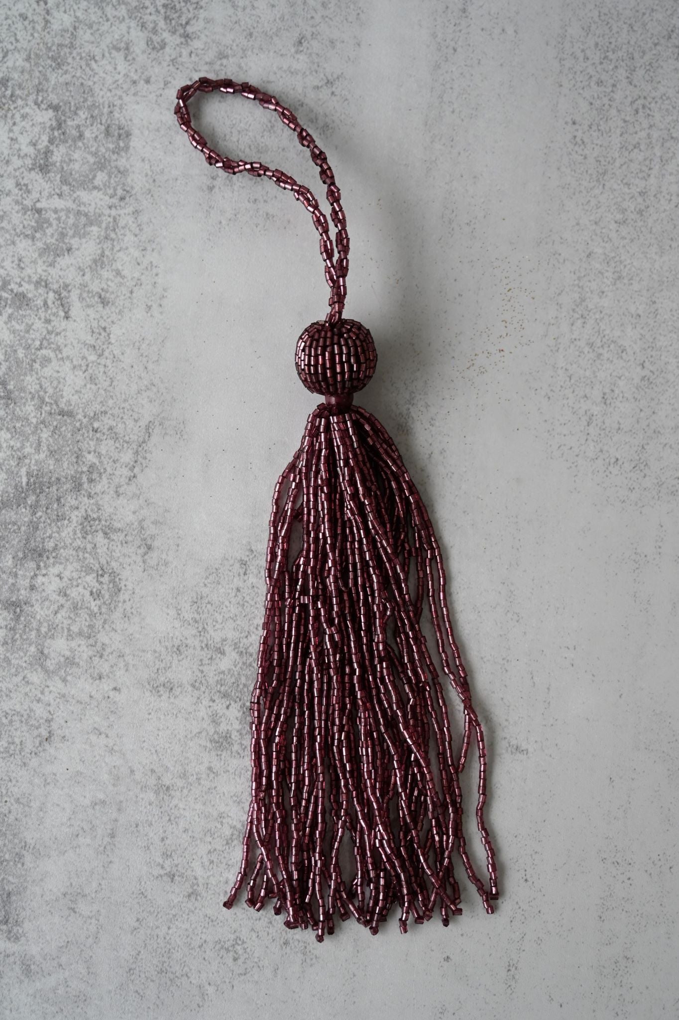 Opulent Art Deco tassel ornament covered in deep purple glass beads.