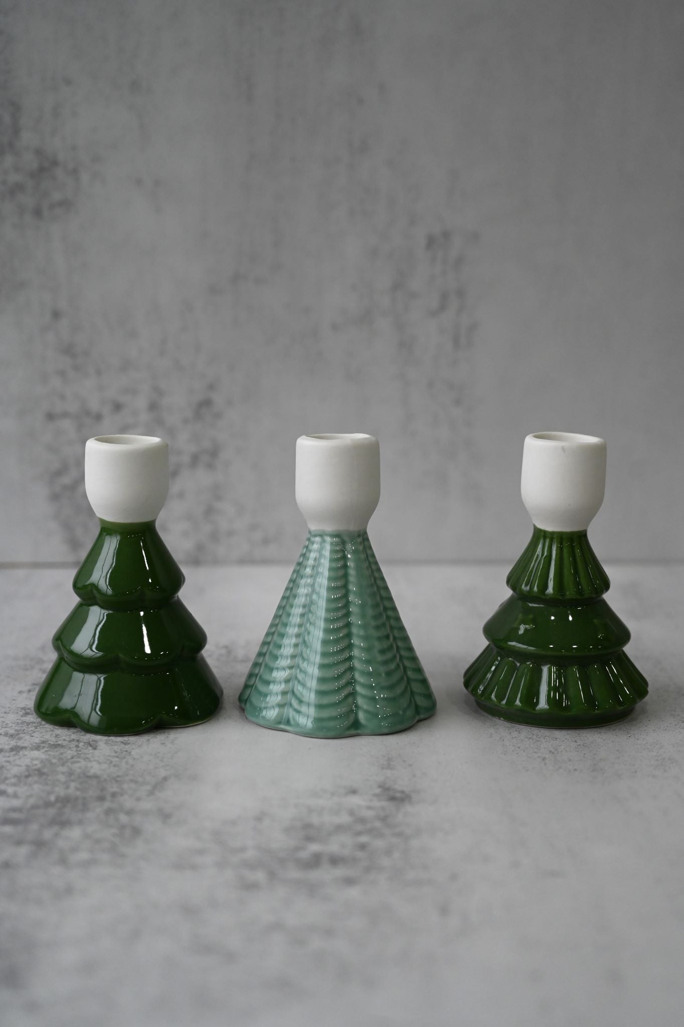 Trio of glossy and textured ceramic Christmas tree taper candle holders.