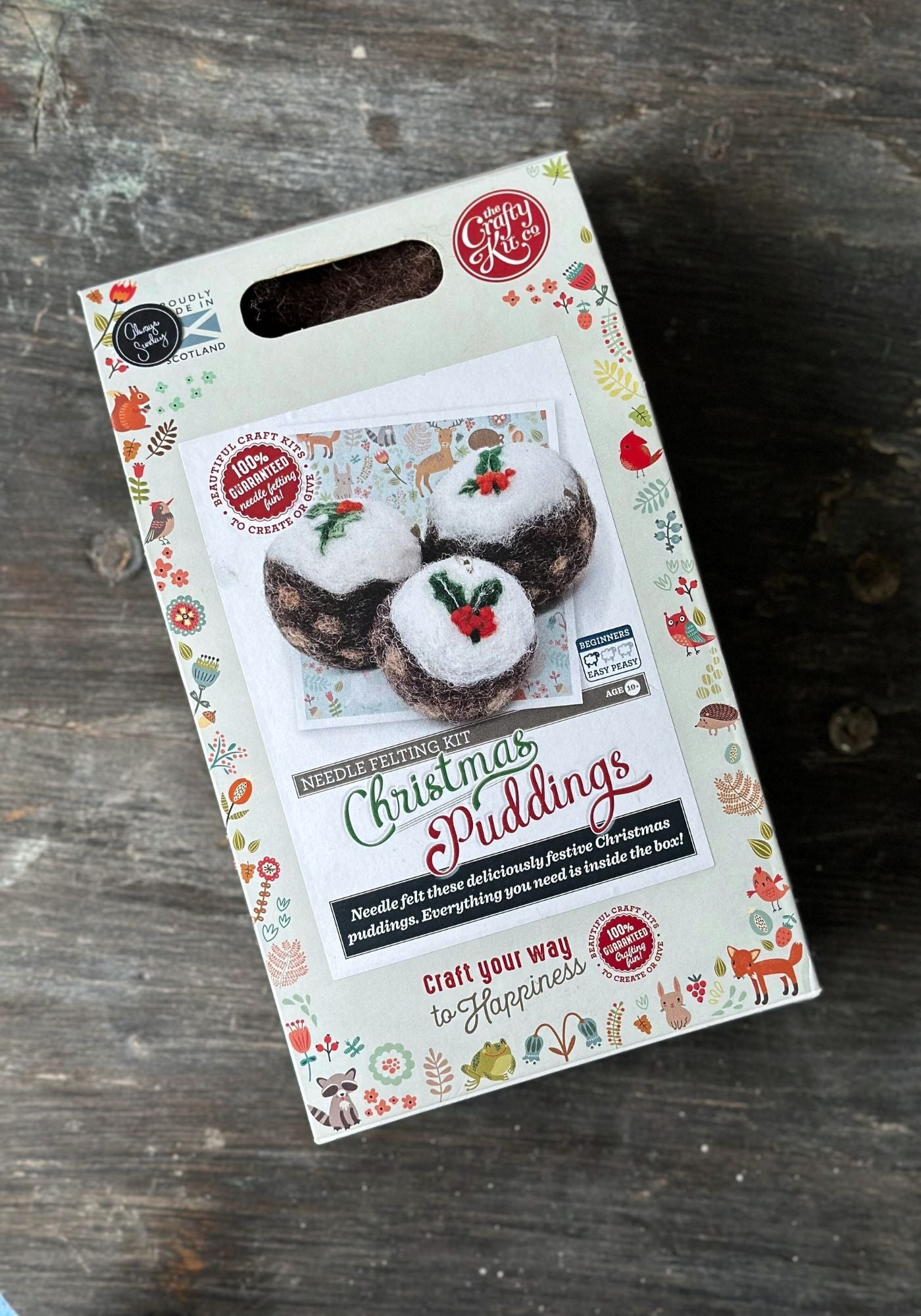 Packaging of Christmas Puddings on a wooden surface