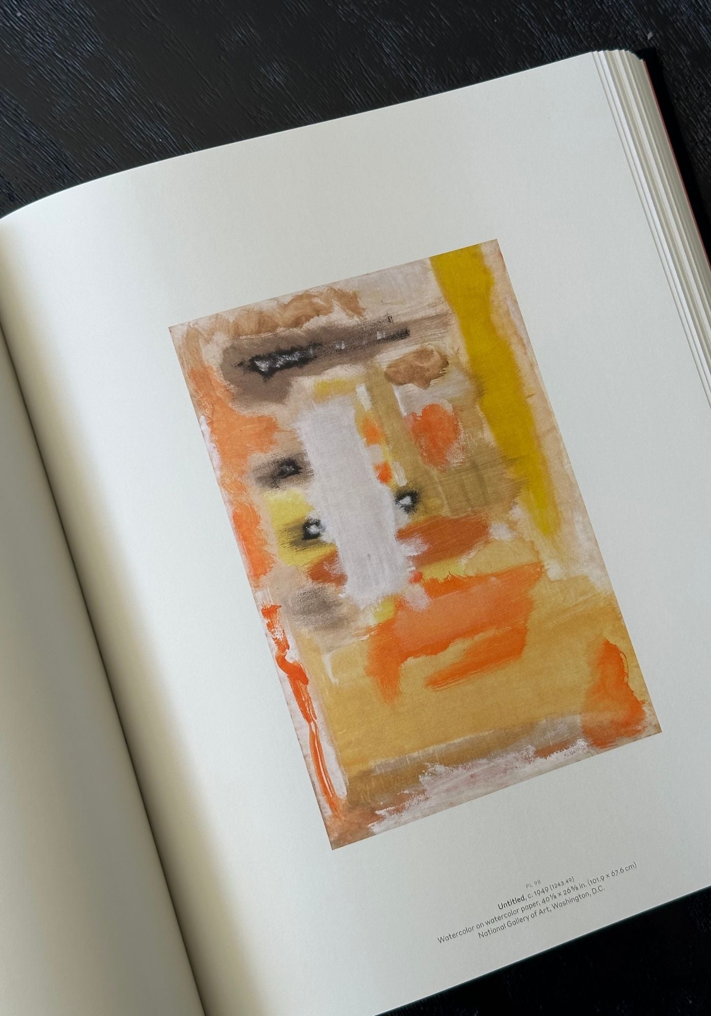 Artistic depiction of a figure with abstract colors on a book page