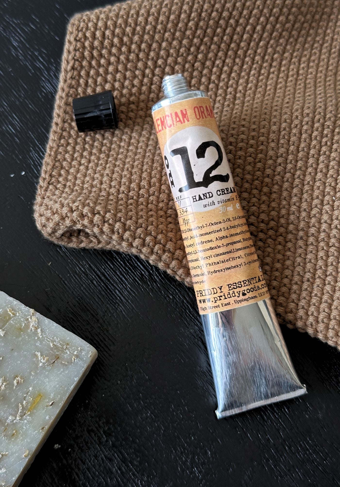 Tube of 12 Hand Cream on a textured surface