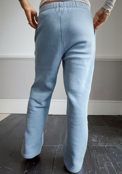 Light blue sweatpants worn by a person on a plain background