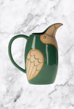 Dark green parrot shaped rustic jug for serving breakfast drinks