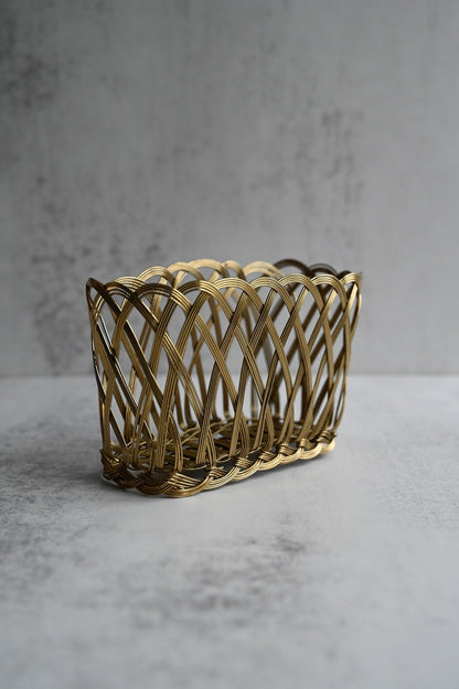 Set of two rectangular gold woven wire baskets with scalloped rims for storage.