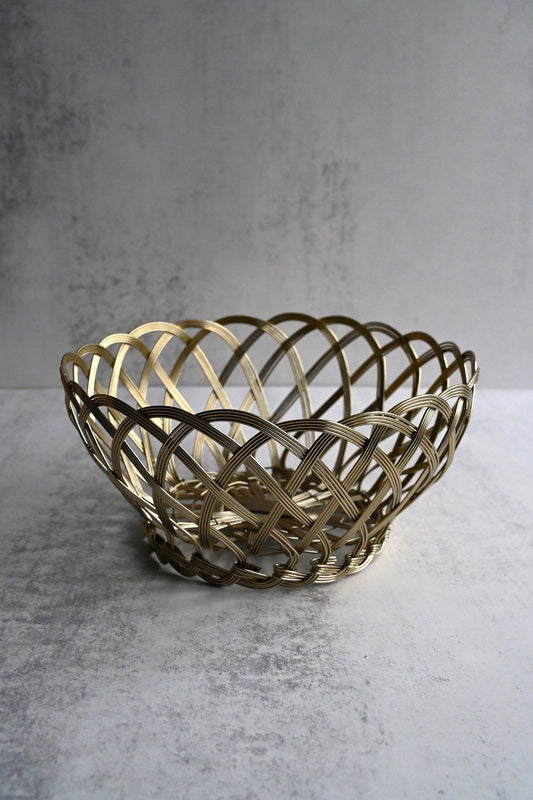 Two circular gold wire baskets with an intricate woven lattice design on a neutral background.