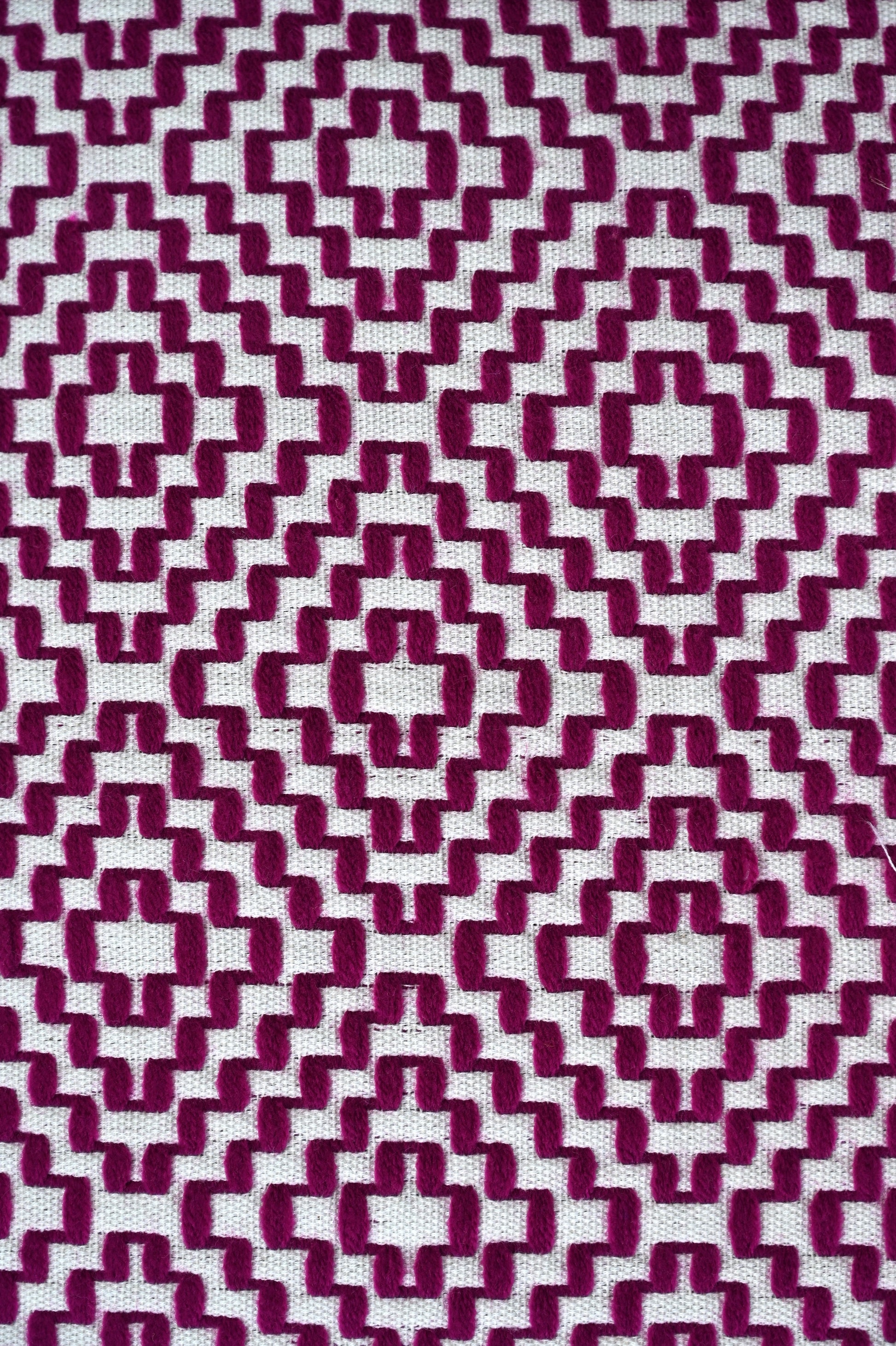 Patterned fabric with a geometric design in purple and white