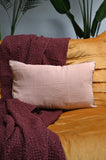 Rectangular pink linen cushions on a sofa