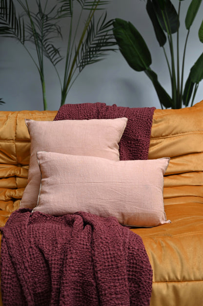 Peach pink linen cushions on a sofa