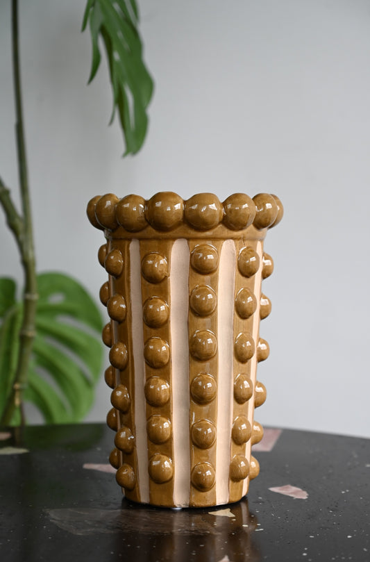 Tall mustard and pink striped ceramic vases with a raised bobble texture and beaded rim.