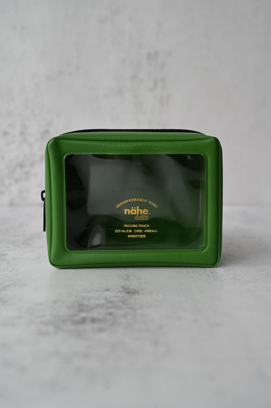 Rainforest green suitcase packing pouches with transparent windows displayed on a wooden shelf.