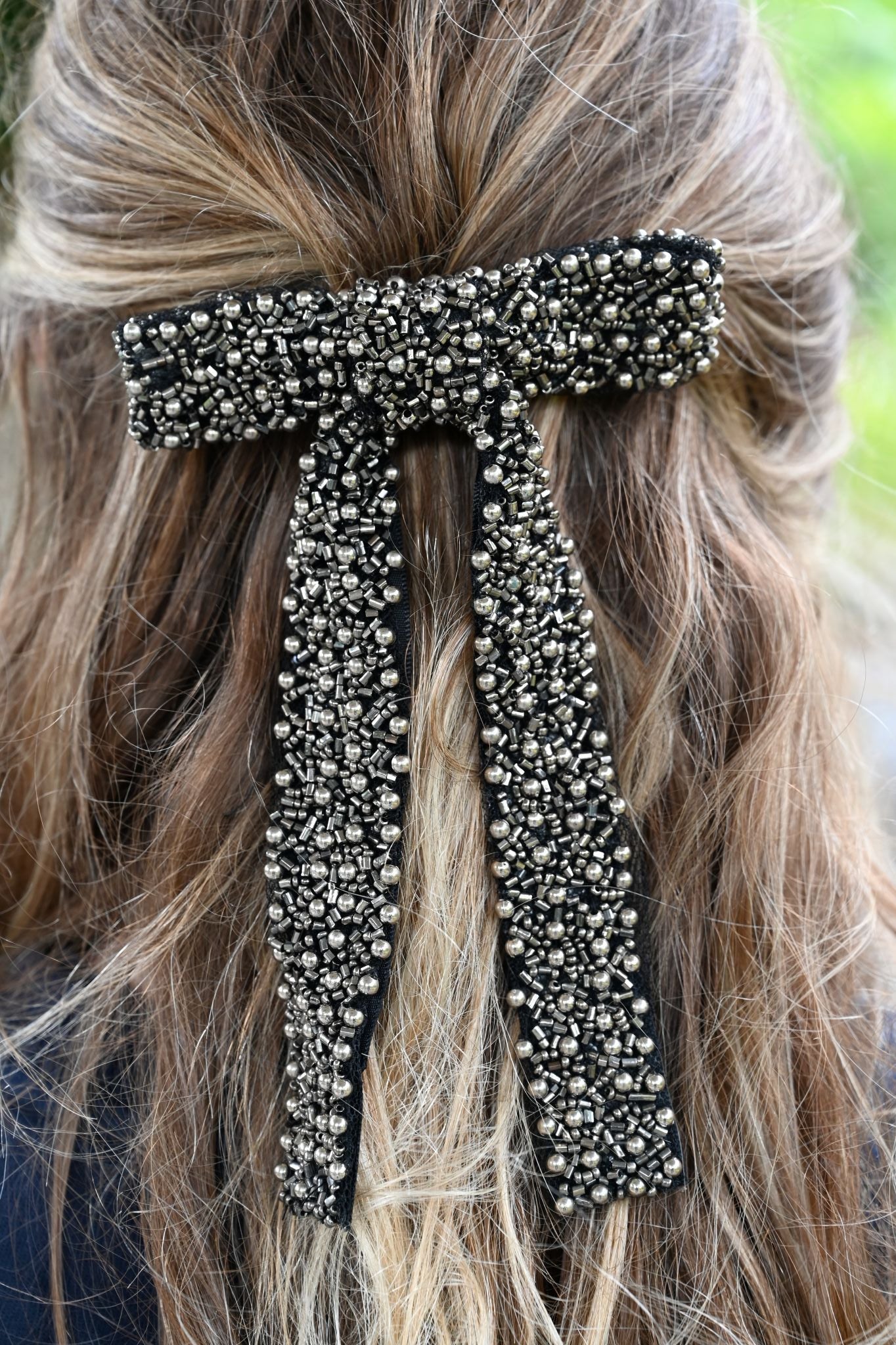 Decorative hair clip with crystals on a person's hair