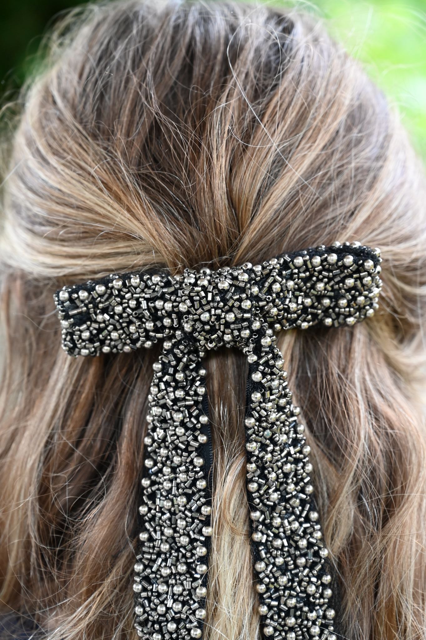Close-up of a hair bun with decorative hair tie