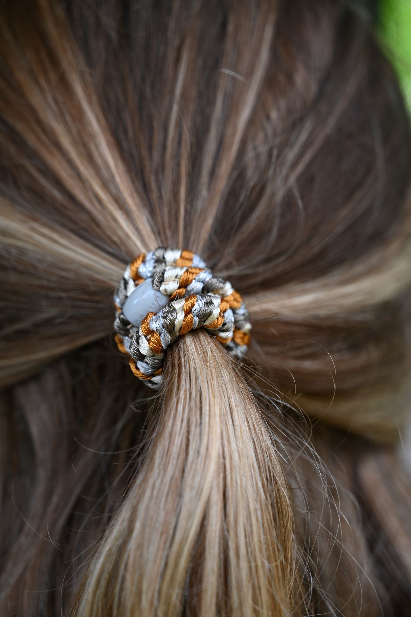 Close-up of a hair tie in a bundle of hair