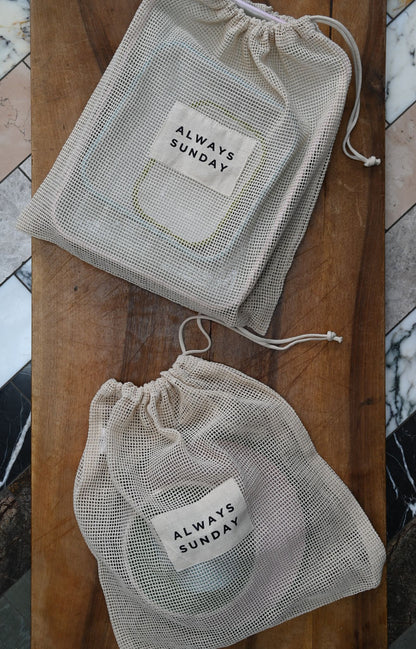 Two mesh bags with 'Always Sunday' label on a wooden surface.
