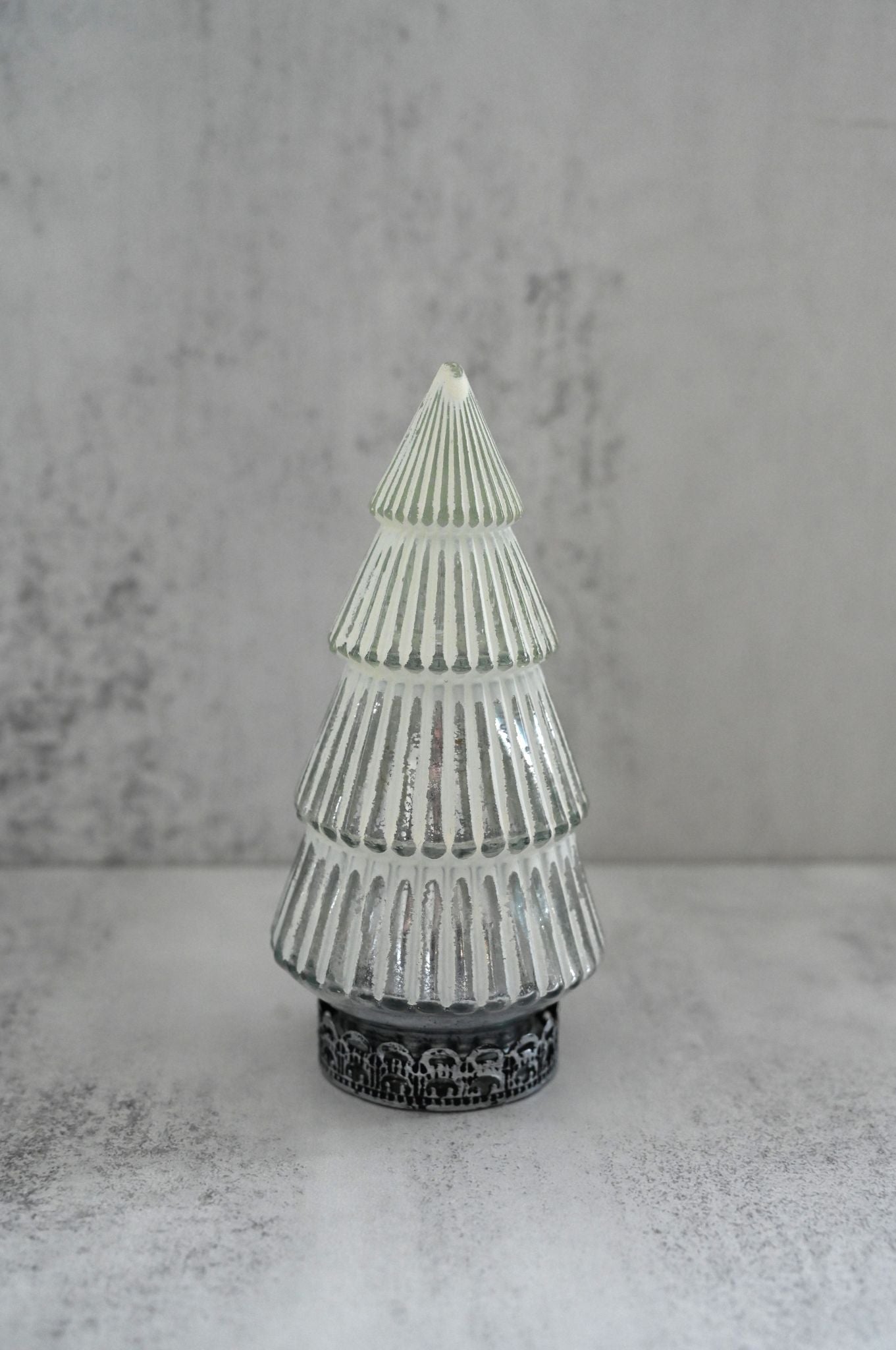 Decorative glass tree with textured design on a gray background