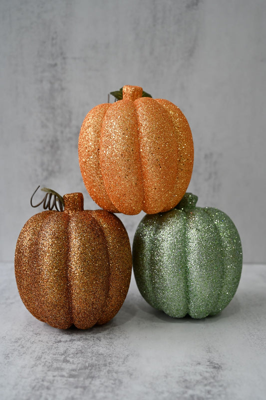 Ensemble de trois grandes citrouilles scintillantes