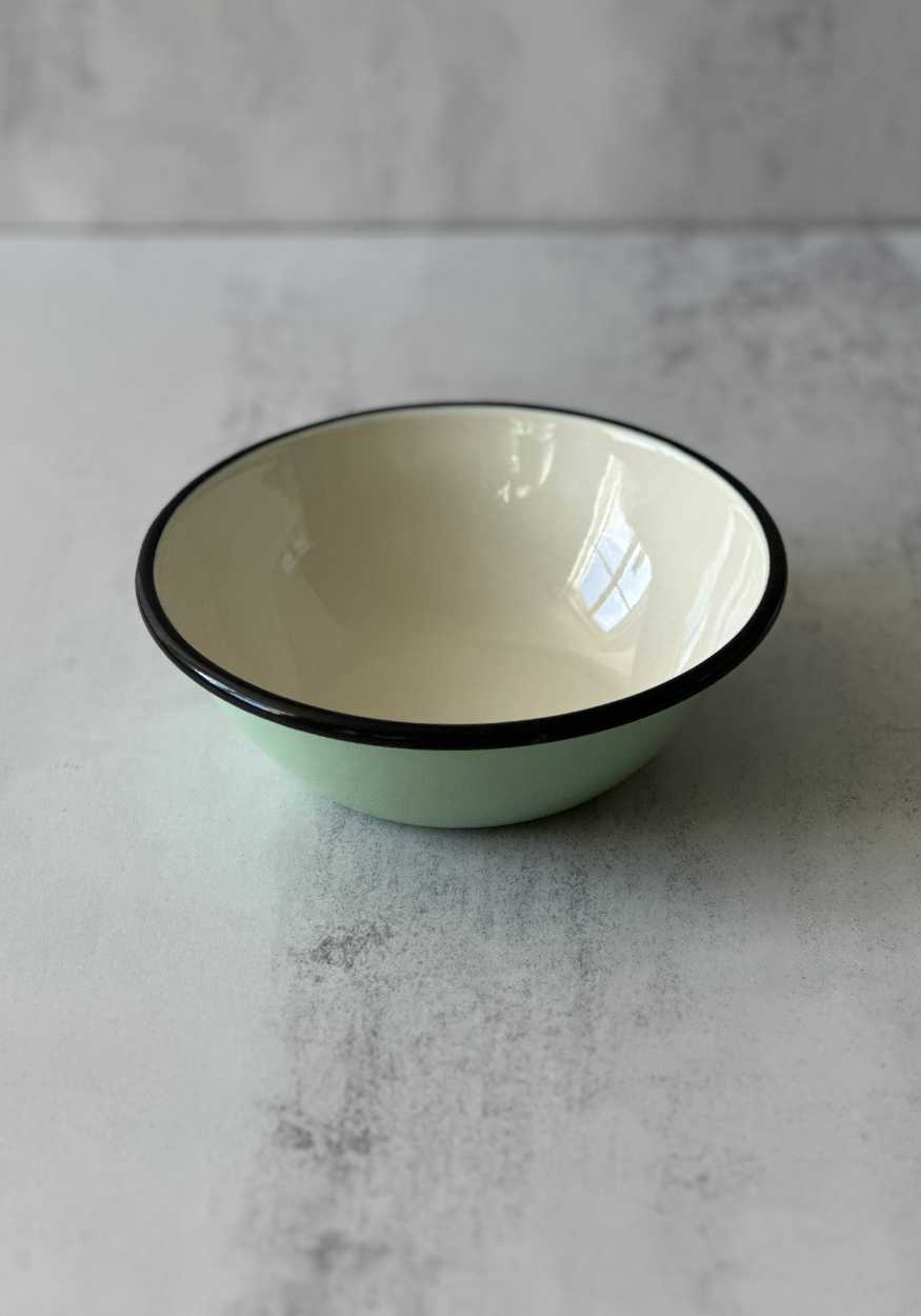 Light blue enamel cereal bowl with a cream interior and a black rim.