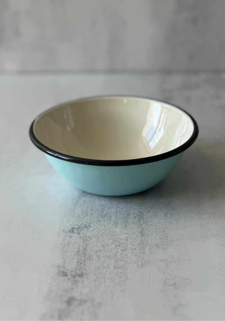 Light blue enamel cereal bowl with a cream interior and a black rim.