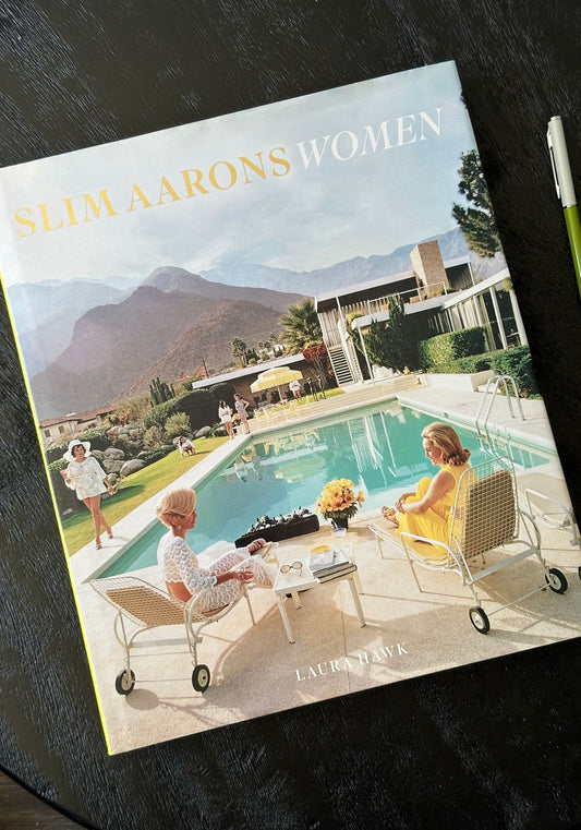 Book titled 'Slim Aarons Women' with a pool scene on the cover