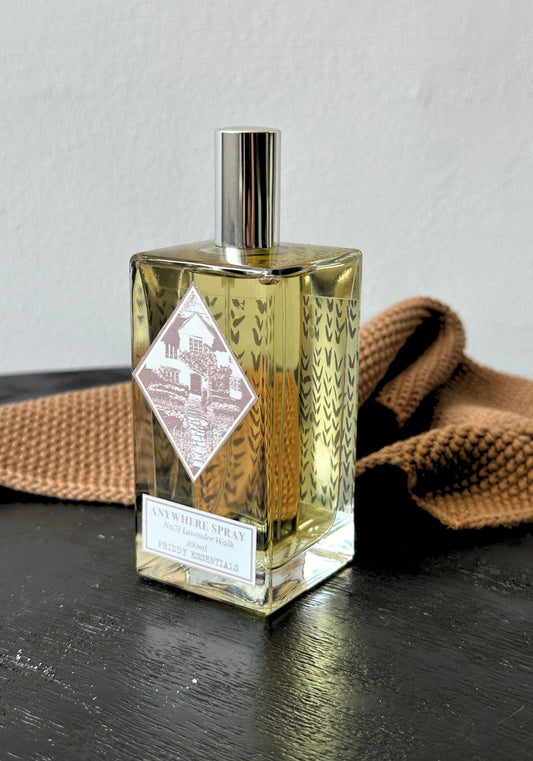 Glass bottle with a label on a dark surface with a brown textured fabric background