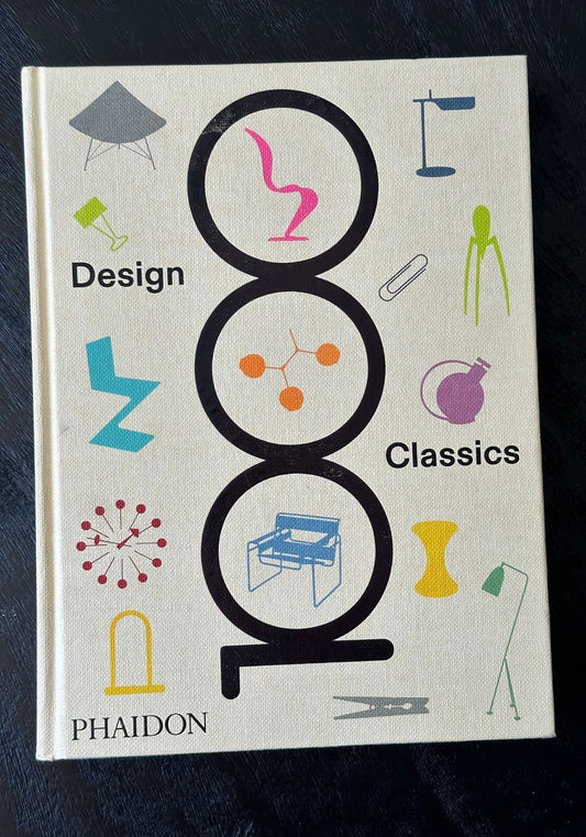 Book titled 'Design Classics' by Phaidon with colorful geometric illustrations on a dark background