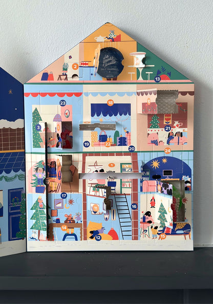 Advent calendar shaped like a house with colorful scenes on each door