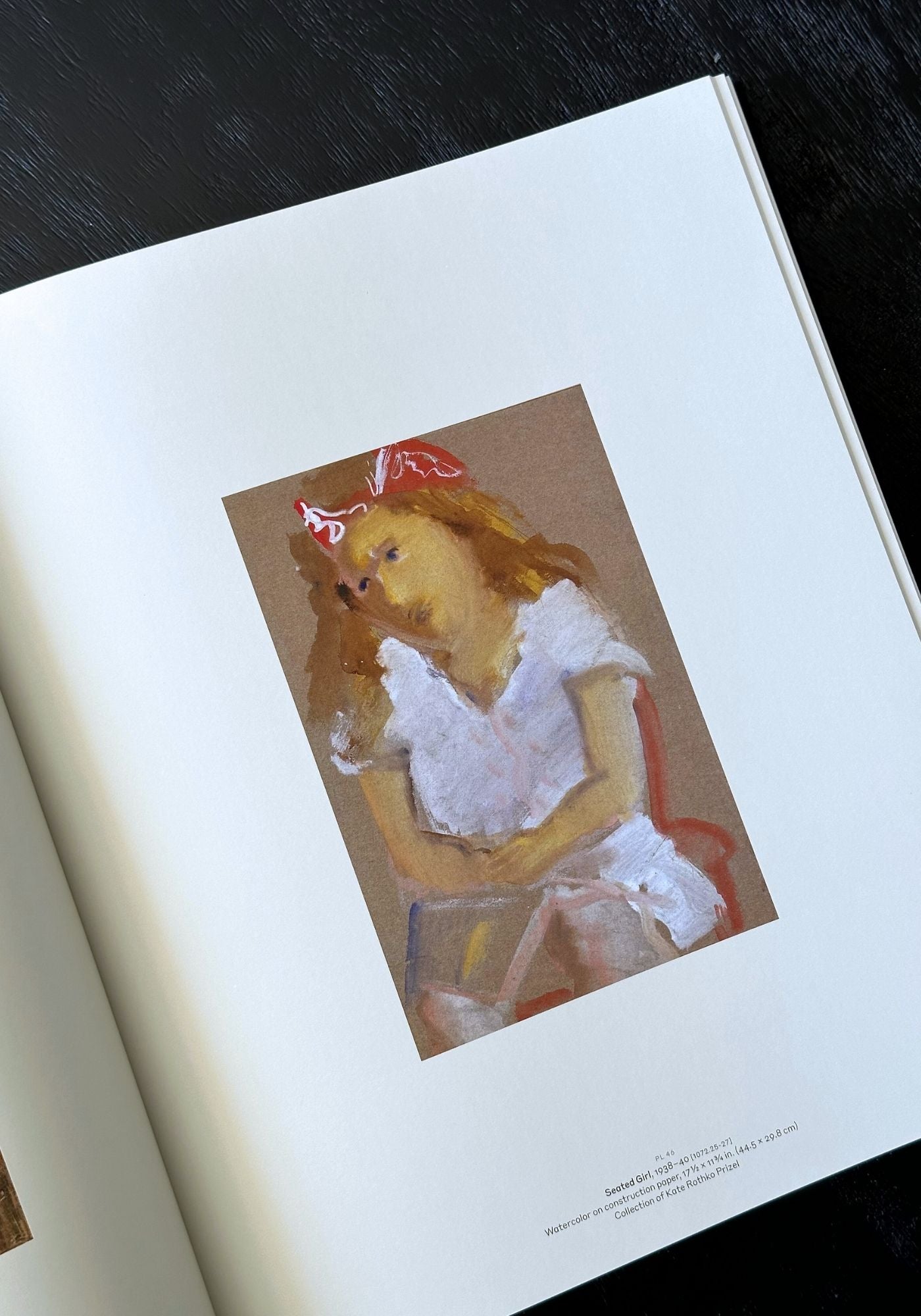 Artistic depiction of a person in a white dress with a red hat on a book page.