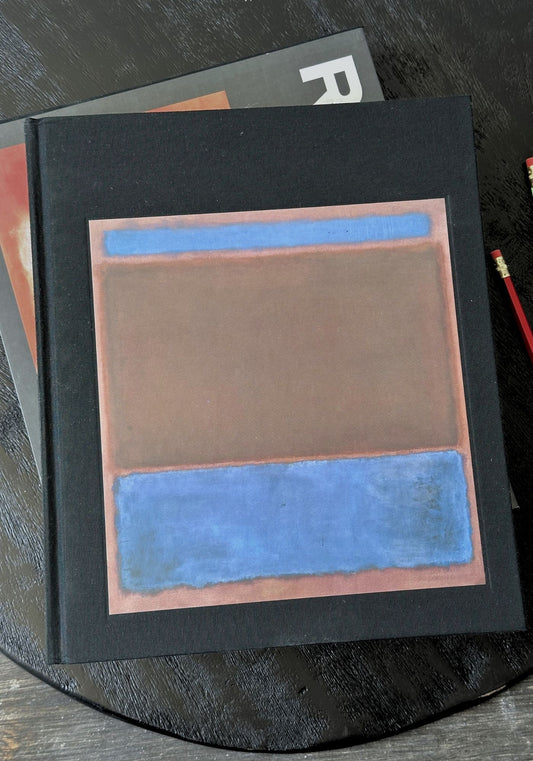 Book with abstract design on a dark surface