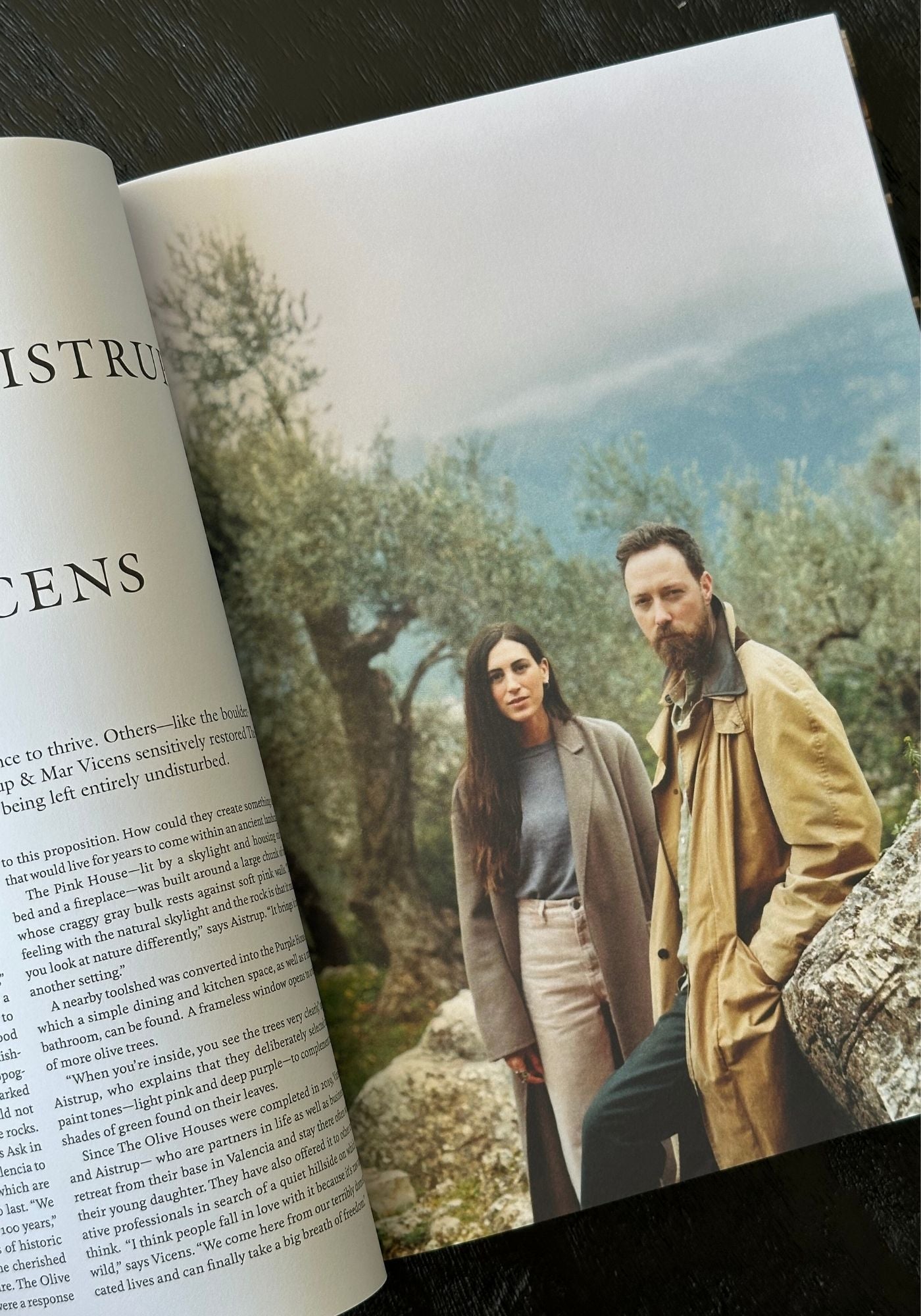 Open book with a photograph of two people standing outdoors on a scenic background