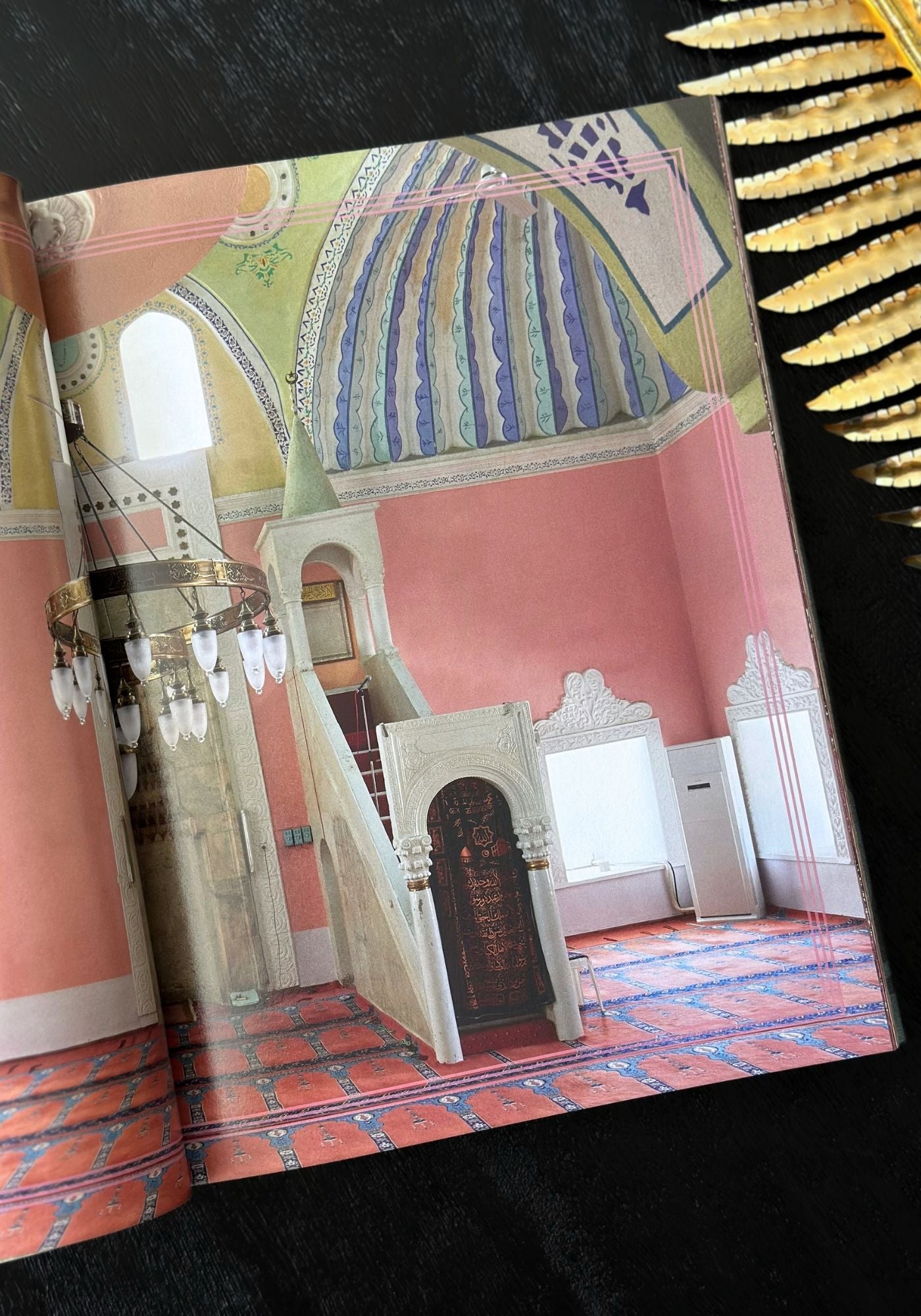 Decorative book with a colorful interior design illustration on a black background